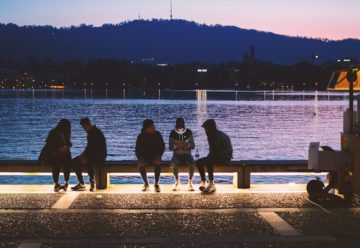 students sitting on bench